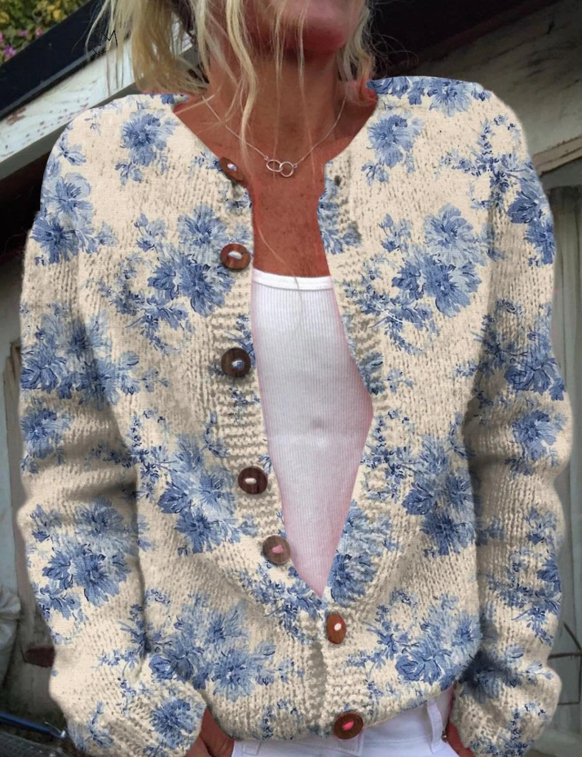 Floral button pullover sweater with cream base, blue blossoms, round neckline, brown buttons