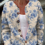 Floral button pullover sweater with cream base, blue blossoms, round neckline, brown buttons