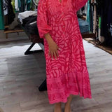 Pink printed V-neck midi dress with 3/4 sleeves, button front, tiered hem