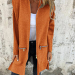 Rust orange hooded zip-front jacket with long sleeves and side zip pockets