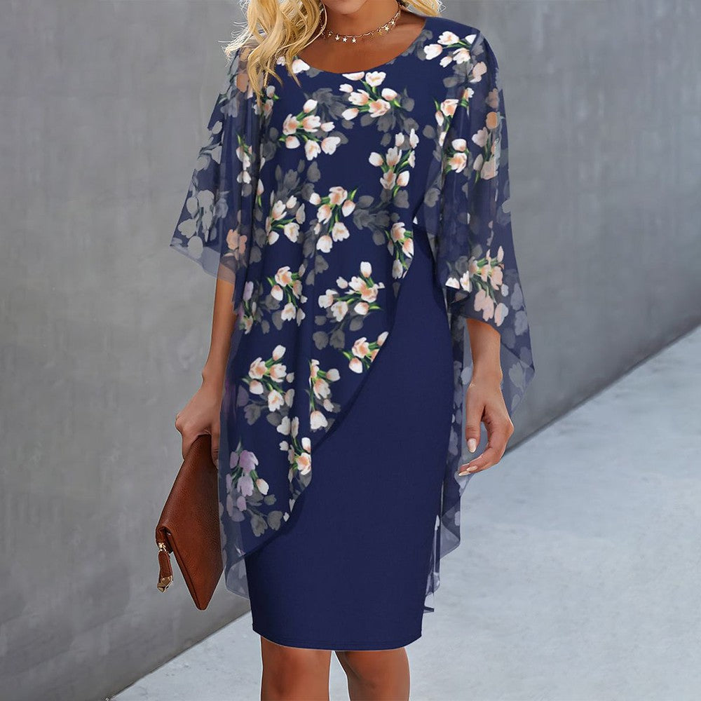 Floral dress with sheer cape sleeves, dark blue base and white/pink blossoms