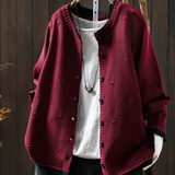 Burgundy structured cardigan with button front, ribbed cuffs, and knit texture