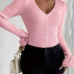 Pink ribbed V-neck button top with lace-trim cuffs and fitted long sleeves