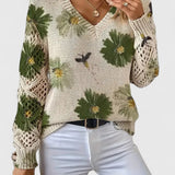 Relaxed floral pullover sweater, cream knit with green floral pattern, V-neck, long sleeves