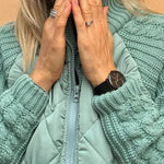 Teal quilted cardigan with full-zip front and chunky knit sleeves