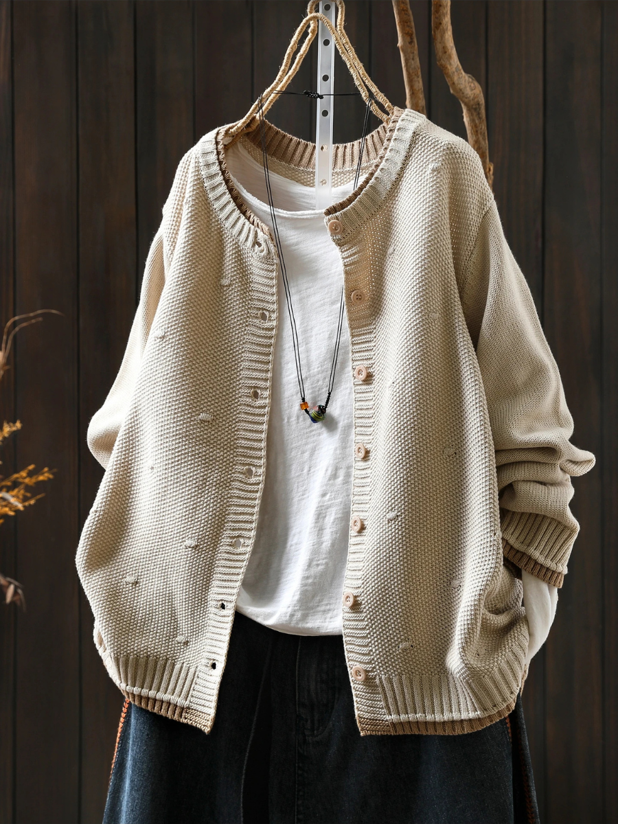 Cream structured cardigan with button front and ribbed cuffs, textured knit fabric