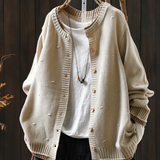 Cream structured cardigan with button front and ribbed cuffs, textured knit fabric