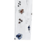 White fabric swatch with floral print in blue and brown tones