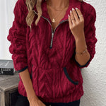 Red fuzzy quarter-zip pullover with short sleeves and navy-trim accents