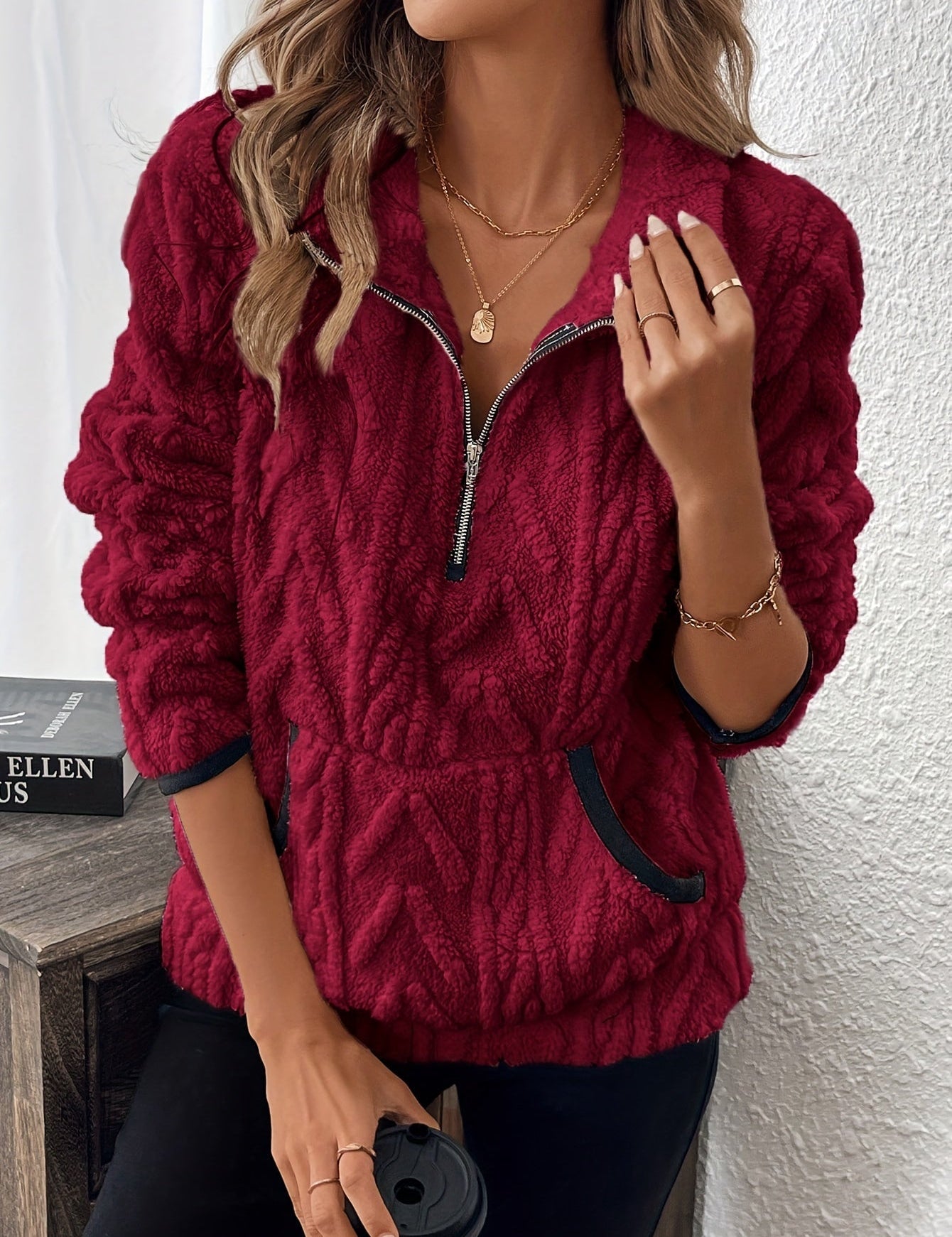 Red fuzzy quarter-zip pullover with short sleeves and navy-trim accents