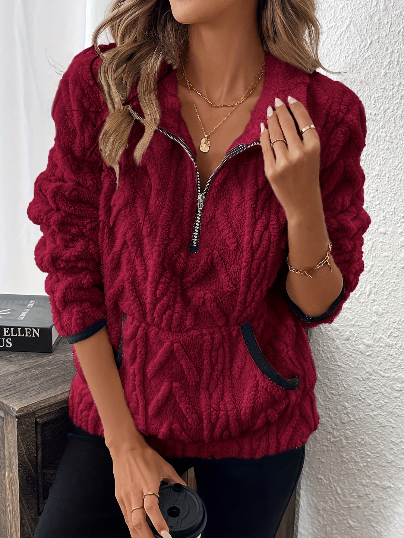 Red fuzzy quarter-zip pullover with short sleeves and navy-trim accents