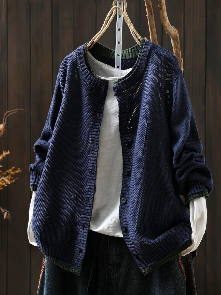 Navy blue structured cardigan with button front and ribbed cuffs, textured knit