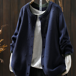 Navy blue structured cardigan with button front and ribbed cuffs, textured knit