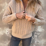 Light beige cable-knit half-zip pullover with long sleeves, ribbed cuffs, zip front
