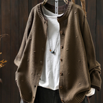 Tan structured cardigan with button front and ribbed cuffs, textured knit fabric