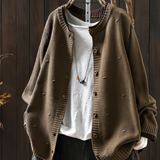 Tan structured cardigan with button front and ribbed cuffs, textured knit fabric