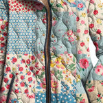 Women's floral quilted jacket front, patchwork print with button placket and dark trim