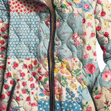 Women's floral quilted jacket front, patchwork print with button placket and dark trim