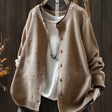 Beige structured cardigan with button placket and ribbed hem, textured knit texture