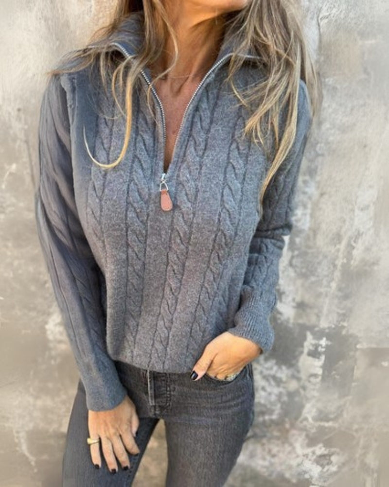 Gray cable-knit half-zip pullover with long sleeves and ribbed cuffs, zip collar