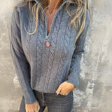 Gray cable-knit half-zip pullover with long sleeves and ribbed cuffs, zip collar