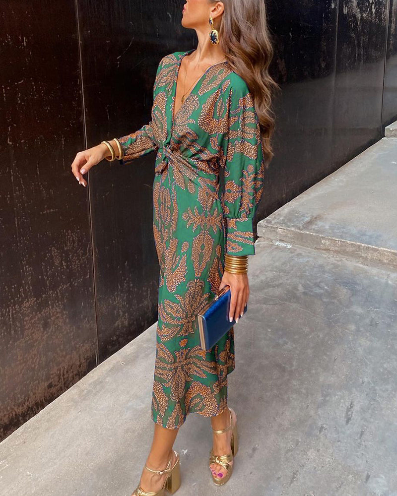 Green patterned midi dress with V-neck, long sleeves, and knotted waist tie