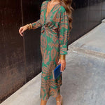 Green patterned midi dress with V-neck, long sleeves, and knotted waist tie