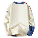 Cream knit sweater with blue ribbed hem and cuffs; cable-trim details on sleeves