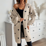 Taupe cardigan with scattered black heart motifs, open front, long sleeves
