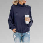 Navy blue chunky knit sweater with ribbed turtleneck, long sleeves, and straight hem