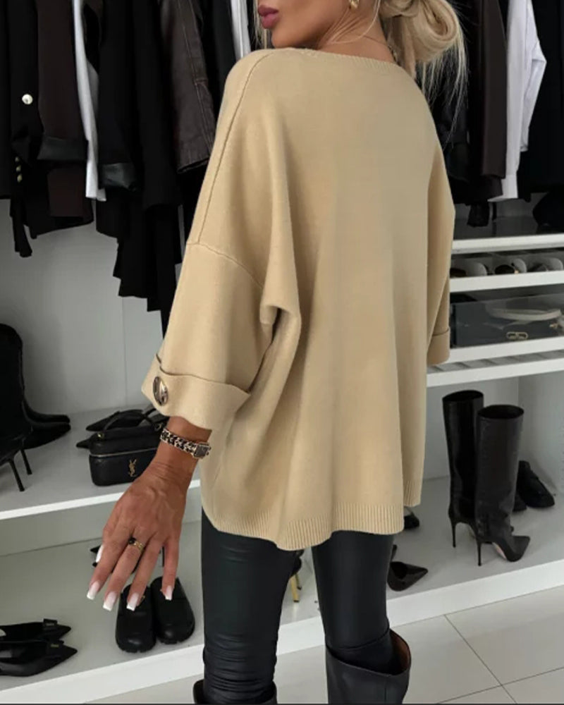 Beige knit pullover back view with wide sleeves and loose fit, ribbed hem
