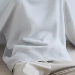 Oversized off-white turtleneck knit sweater with ribbed hem
