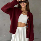 Wine red knit cardigan with multicolor button placket and long sleeves, worn open