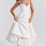 White sleeveless corset dress with thin straps and layered flared midi skirt