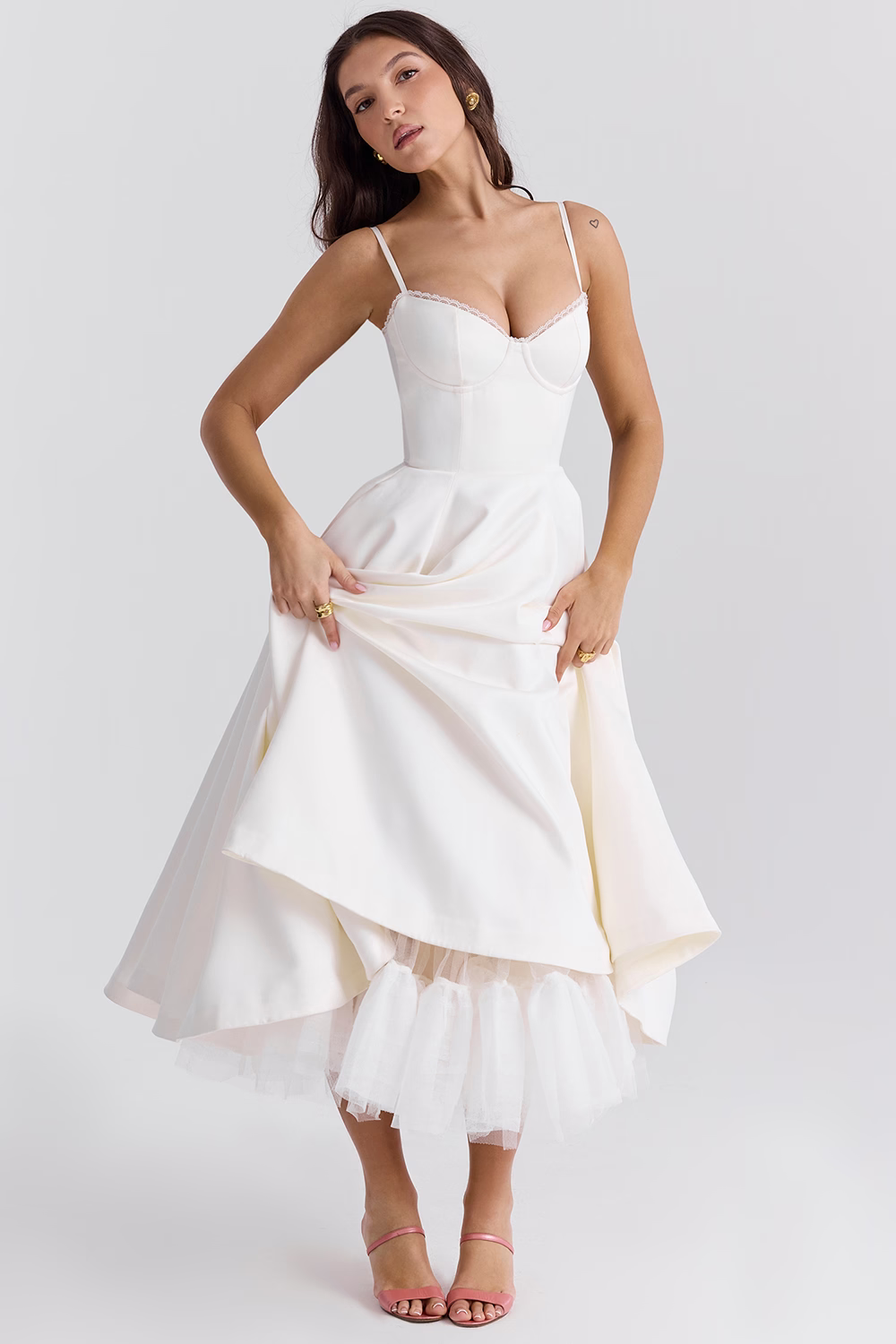 White sleeveless corset dress with thin straps and layered flared midi skirt