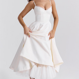 White sleeveless corset dress with thin straps and layered flared midi skirt