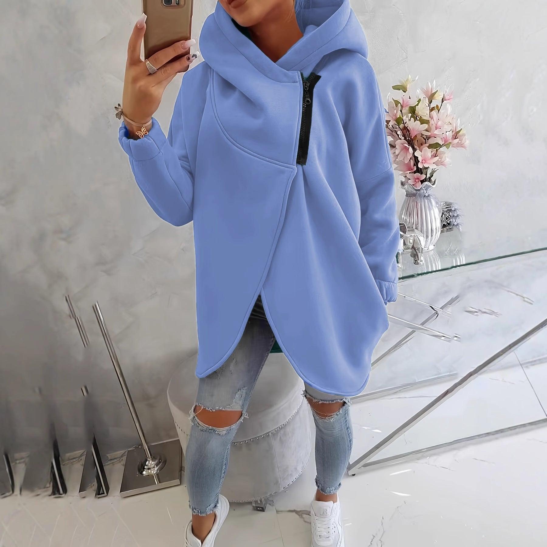 Light blue zip-up hoodie with hood, front pocket, and black zipper trim
