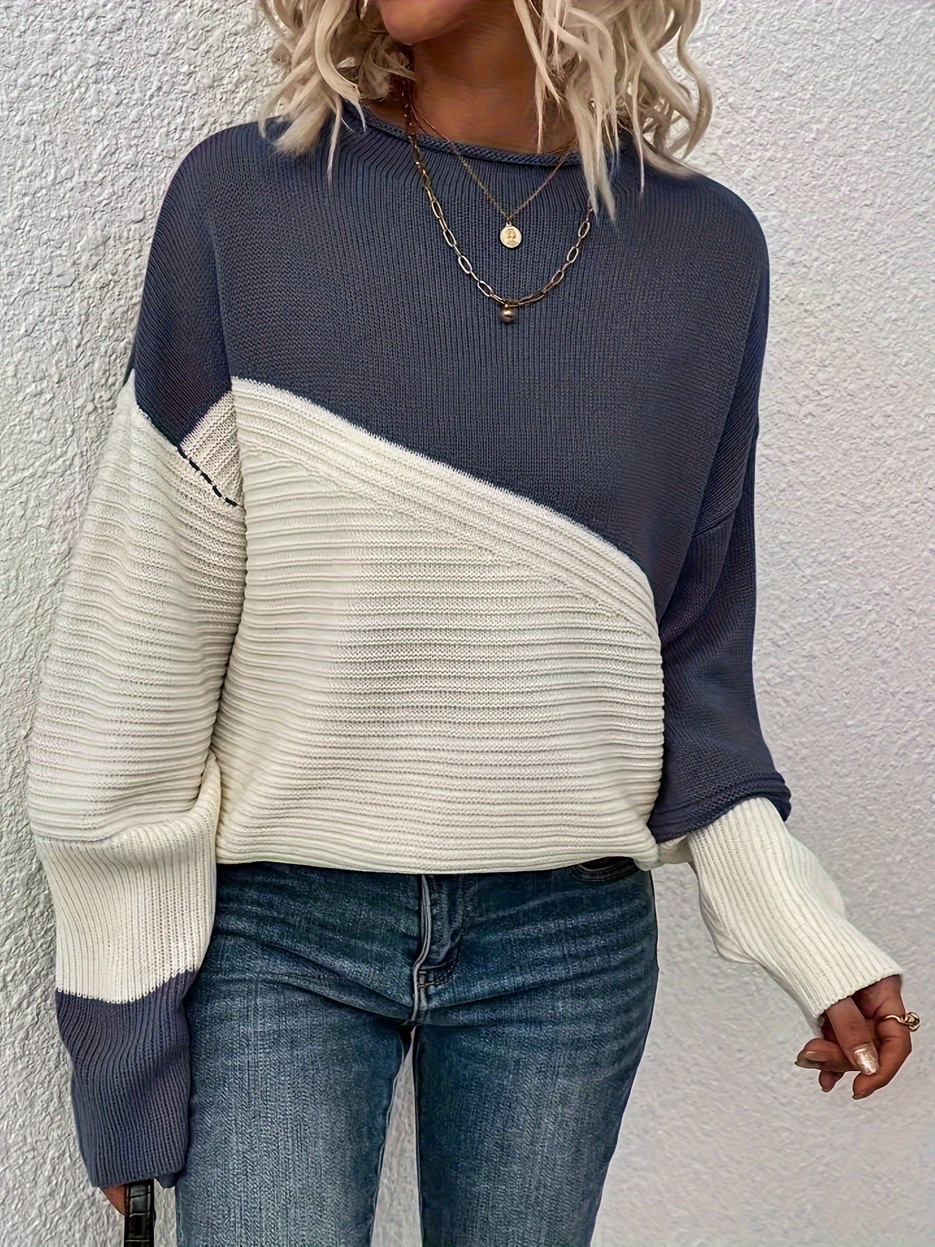 Navy blue and white color-block pullover sweater with long sleeves and crew neck
