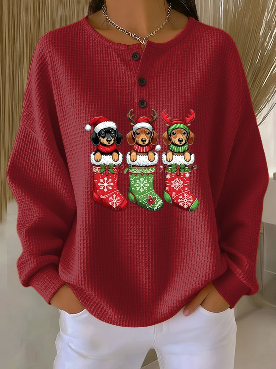 Red vintage Christmas henley sweater with dog motif and festive stockings graphic