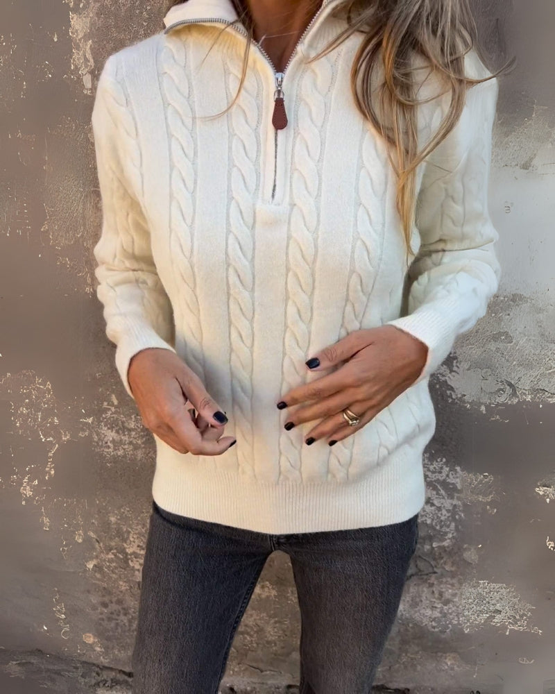 Cream cable-knit half-zip pullover with long sleeves and ribbed cuffs, zipper front