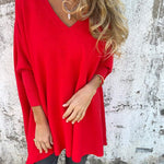 Red V-neck pullover sweater with wide sleeves and relaxed A-line shape.