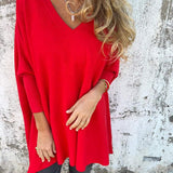 Red V-neck pullover sweater with wide sleeves and relaxed A-line shape.