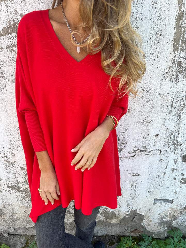 Red V-neck pullover sweater with wide sleeves and relaxed A-line shape.
