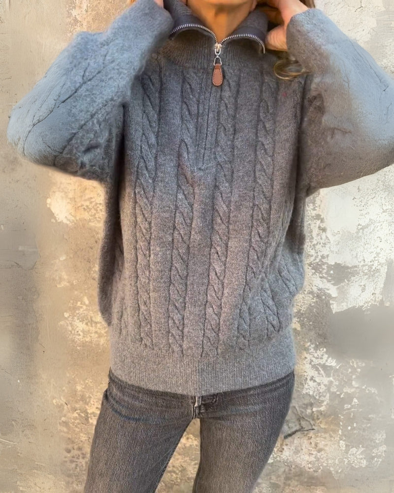 Dark gray cable-knit half-zip pullover with textured cable pattern and ribbed hem