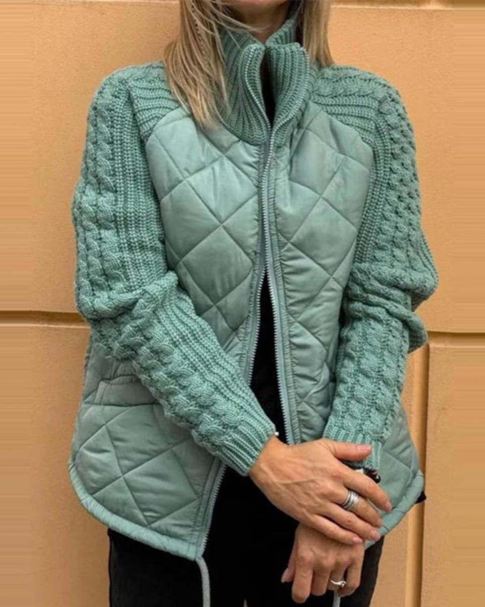 Teal quilted cardigan vest with front zipper and textured knit sleeve panels