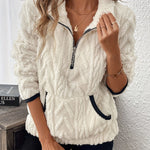 White fuzzy quarter-zip pullover with short sleeves and navy-trim accents