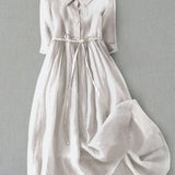 White button-front tie-waist dress with 3/4 sleeves and gathered skirt.
