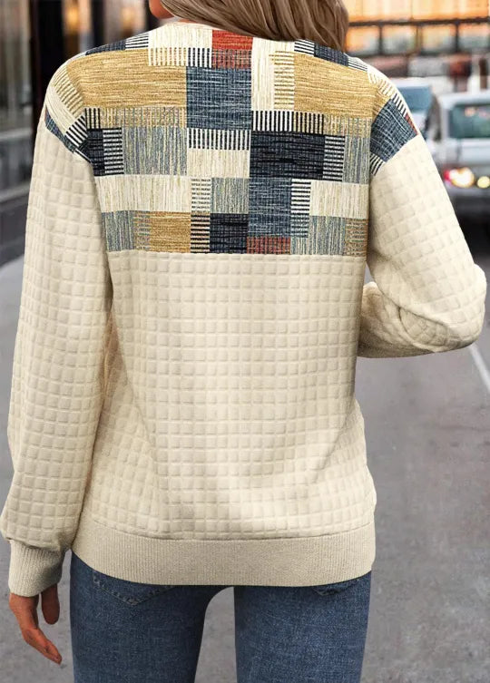 Cream knit sweater with square patchwork on upper back and waffle texture