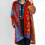 Multicolor knit cardigan with open front and long sleeves, orange and rust patchwork