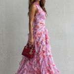 Pink floral halter maxi dress with ruched bodice and layered ruffle skirt, side view